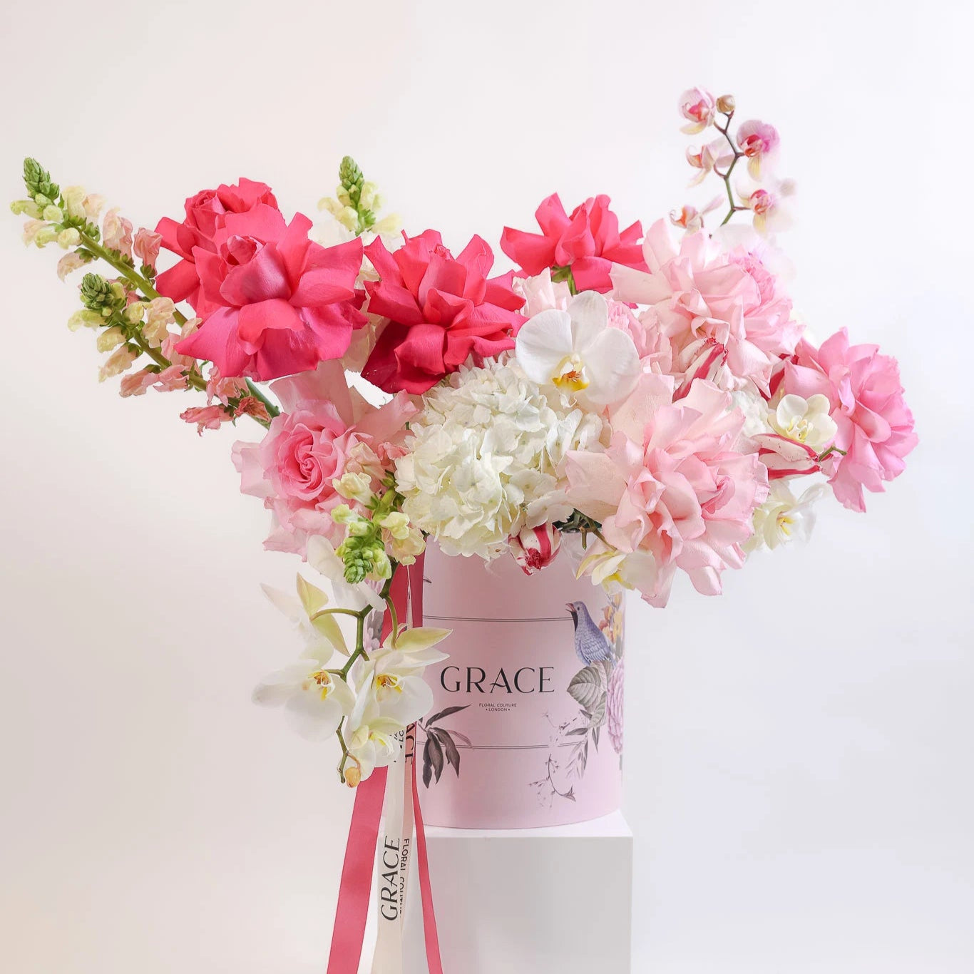 Bouquet of pink and white flowers in a 'Grace' box on a white background