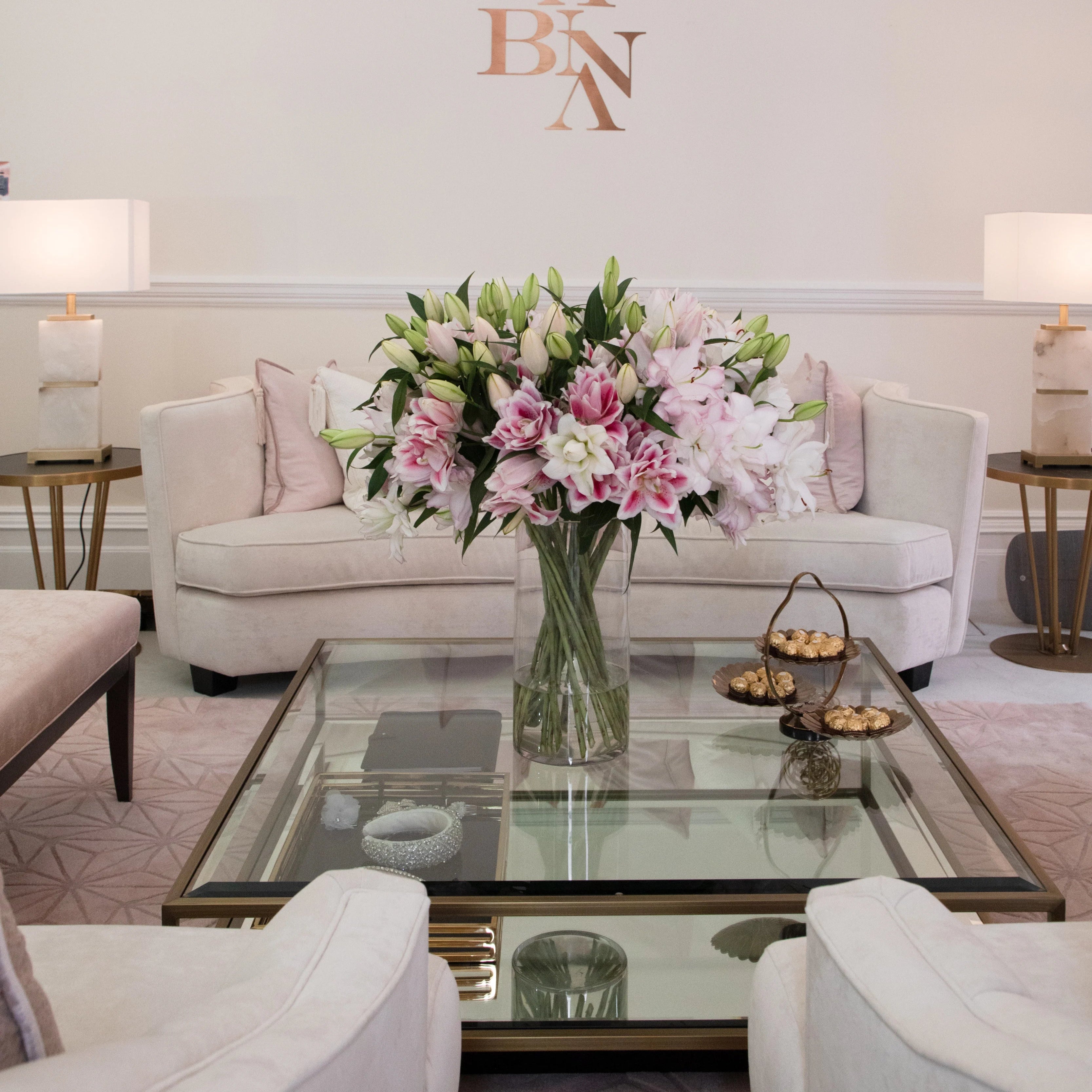 Living room with a floral arrangement on a glass coffee table