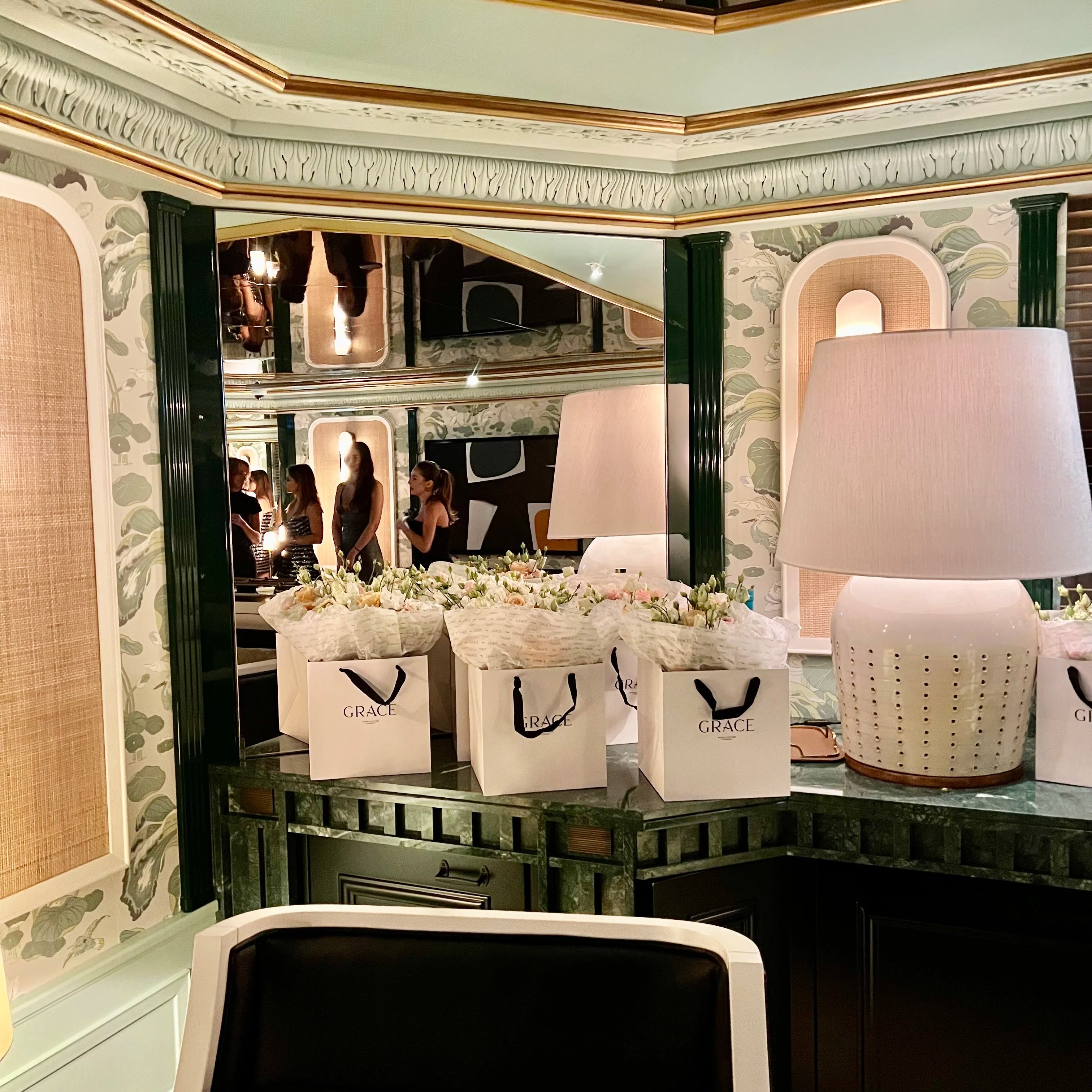 Decorative setup with lamps, baskets, and a mirror in an elegant interior setting.