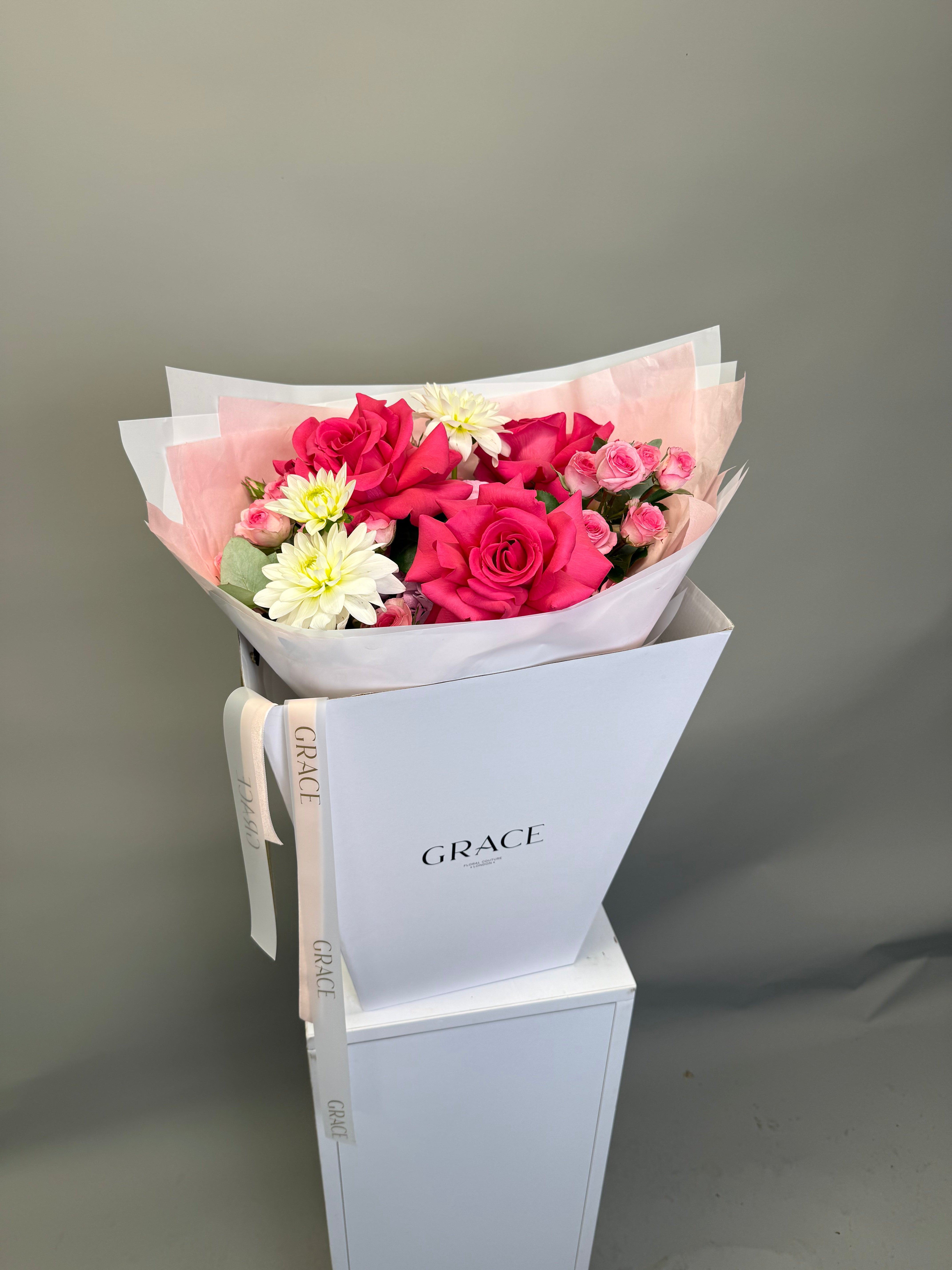 Pink Roses bouquet from Grace Floral London — bright pink roses, pink spray roses, white dahlia and pink hydrangea in white GRACE branded gift box